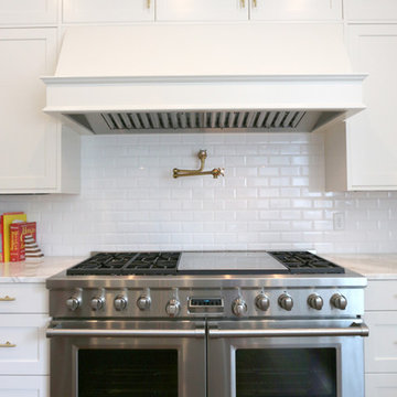 Recessed Cabinet Doors, Wood Island Countertop, and A Custom Hood Defines Style
