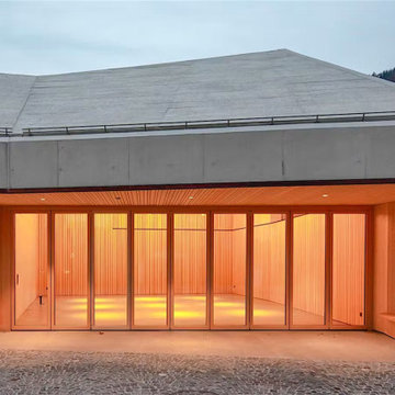 NW Wood 540 Folding Glass Doors Glow at Dusk, Berneck Residence