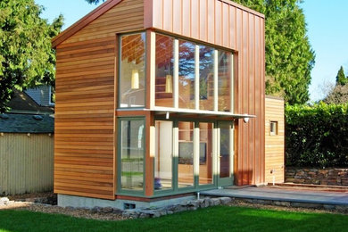 Example of a small one-story wood flat roof design in Seattle