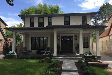 Inspiration for a transitional white two-story brick house exterior remodel in Salt Lake City with a hip roof and a metal roof