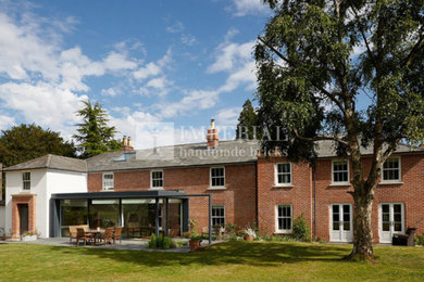 Inspiration for an expansive and red two floor brick detached house in Hampshire.