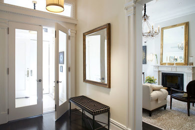 Photo of a large traditional vestibule in New York with beige walls, a double front door and a glass front door.