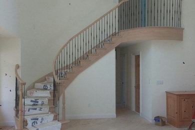 Curved Stair featuring Iron Balusters
