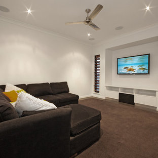 Mid-sized trendy enclosed home theater photo in Cairns with white walls and a wall-mounted tv