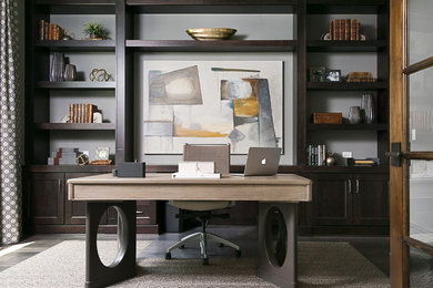 Transitional freestanding desk dark wood floor study room photo in Tampa with gray walls