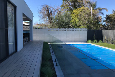 Photo of a large modern backyard partial sun xeriscape in Melbourne with concrete pavers.