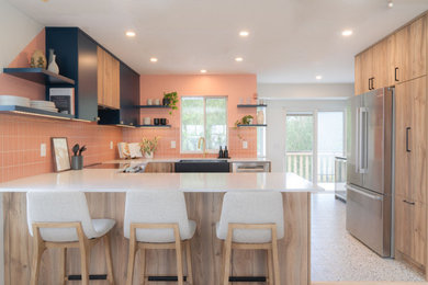 Inspiration for a small transitional u-shaped terrazzo floor and white floor eat-in kitchen remodel in Vancouver with a farmhouse sink, flat-panel cabinets, light wood cabinets, quartz countertops, pink backsplash, porcelain backsplash, stainless steel appliances, an island and white countertops
