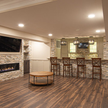 Basement Showing Warm Colors, Straight Lined Cabinets and Stacked Stone