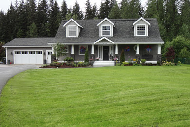 Example of a mid-sized arts and crafts gray two-story concrete fiberboard exterior home design in Other