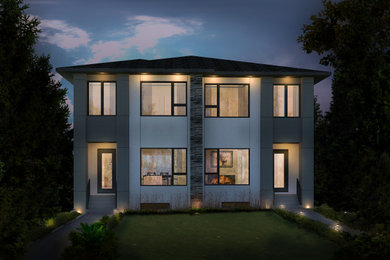 Mid-sized minimalist white two-story stucco duplex exterior photo in Calgary with a shingle roof