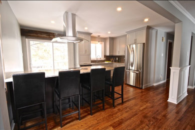 Eat-in kitchen - craftsman l-shaped medium tone wood floor eat-in kitchen idea in Ottawa with a double-bowl sink, shaker cabinets, white cabinets, granite countertops, beige backsplash, ceramic backsplash, stainless steel appliances and an island