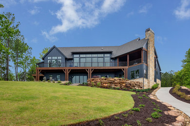 Example of a large trendy blue two-story concrete fiberboard and board and batten exterior home design in Other with a gray roof