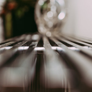 Inspiration for a large modern home office and library in Edmonton with grey walls, ceramic flooring and a hanging fireplace.