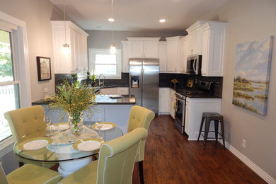 Inspiration for a mid-sized contemporary u-shaped medium tone wood floor eat-in kitchen remodel in Dallas with a peninsula, shaker cabinets, white cabinets, black backsplash, a double-bowl sink, granite countertops, stone tile backsplash and stainless steel appliances