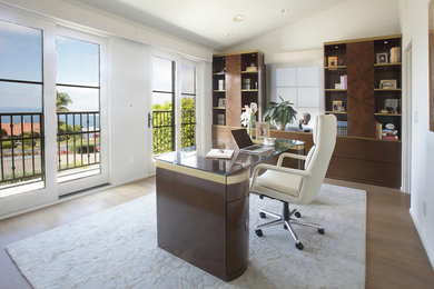 Inspiration for a mid-sized contemporary freestanding desk light wood floor study room remodel in Los Angeles with white walls