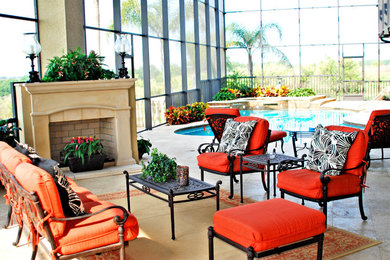 Large elegant backyard concrete paver patio photo in Orlando with a gazebo