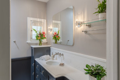 Small elegant white tile and marble tile porcelain tile, single-sink and wainscoting bathroom photo in Denver with black cabinets, an undermount sink, quartz countertops, white countertops and a built-in vanity