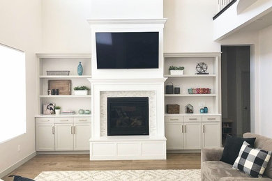 Inspiration for a mid-sized transitional open concept medium tone wood floor and brown floor family room remodel in Salt Lake City with white walls, a standard fireplace, a wall-mounted tv and a tile fireplace