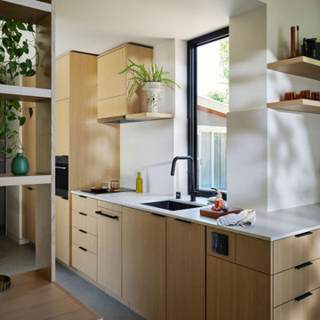 Modern ADU Kitchen with Rift-Cut Oak Cabinets and Vertical Marvin Window