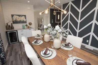 Inspiration for a mid-sized contemporary dark wood floor and brown floor great room remodel in Other with beige walls and no fireplace