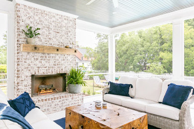 Large beach style screened-in back porch photo in Charleston with a roof extension