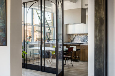 Inspiration for a mid-sized l-shaped medium tone wood floor and brown floor eat-in kitchen remodel in New York with an undermount sink, flat-panel cabinets, medium tone wood cabinets, marble countertops, green backsplash, marble backsplash, paneled appliances, an island and green countertops