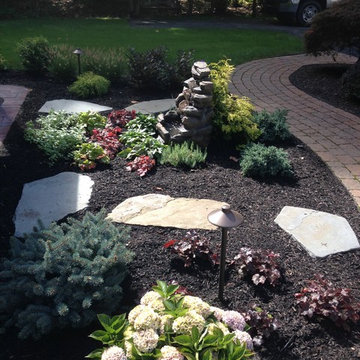 Gazebo and outdoor fireplace with sitting wall and small fountian