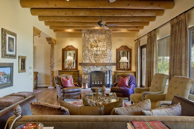 Living room - mid-sized southwestern formal and open concept dark wood floor and brown floor living room idea in Albuquerque with beige walls, a standard fireplace, a stone fireplace and no tv