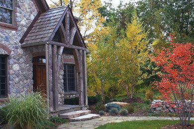 Example of a mid-sized mountain style gray two-story stone gable roof design in Detroit