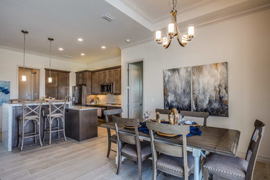 Transitional ceramic tile and gray floor dining room photo in Other with gray walls