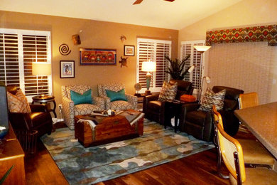 Mid-sized eclectic open concept medium tone wood floor family room photo in Phoenix with beige walls and a tv stand
