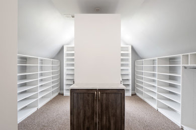 Example of a large trendy gender-neutral carpeted walk-in closet design in DC Metro