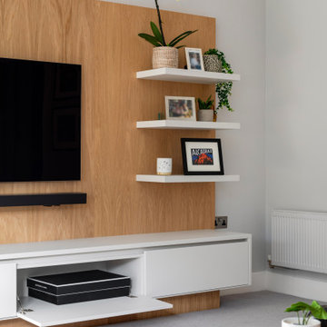 LUXURY FULLY FITTED LIVING ROOM WITH BESPOKE BOOKCASES AND MEDIA WALL