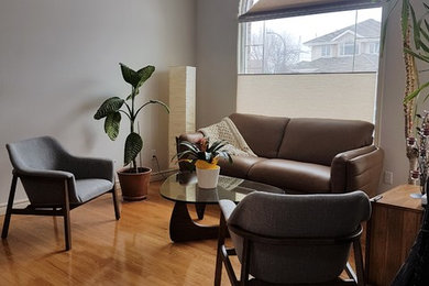 Mid-sized eclectic formal and loft-style light wood floor living room photo in Edmonton with white walls, no fireplace and no tv