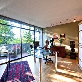 Photo of a large modern study in Vancouver with beige walls, bamboo flooring, a freestanding desk, no fireplace and beige floors.