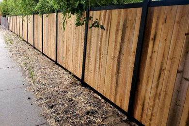 Photo of a full sun side yard wood fence landscaping in Boise for summer.