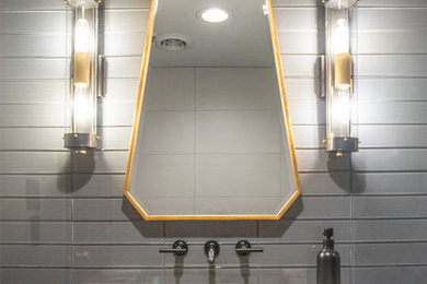 Alcove shower - mid-sized contemporary gray tile and glass tile concrete floor, gray floor and single-sink alcove shower idea in Other with a two-piece toilet, beige walls, an integrated sink, quartzite countertops, a hinged shower door, multicolored countertops and a floating vanity