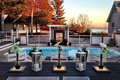 Example of a mid-sized trendy backyard concrete paver and round lap pool design in Toronto