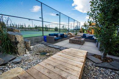 Example of a mid-sized classic courtyard concrete paver patio design with a fire pit and no cover