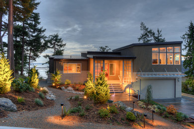 This is an example of a mid-sized modern sloped full sun garden in Seattle with a garden path and gravel.