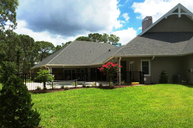 Inspiration for a mid-sized timeless yellow two-story stucco exterior home remodel in Miami with a shed roof