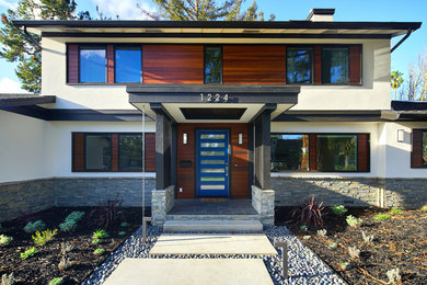 Large trendy white two-story stucco exterior home photo in San Francisco with a shingle roof