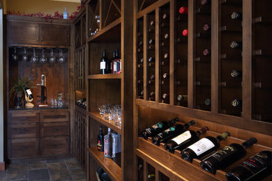 Example of a mid-sized classic slate floor wine cellar design in Other