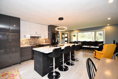 Example of a mid-sized minimalist galley vinyl floor and gray floor eat-in kitchen design in Toronto with a drop-in sink, flat-panel cabinets, gray cabinets, laminate countertops, blue backsplash, glass tile backsplash, black appliances, an island and white countertops