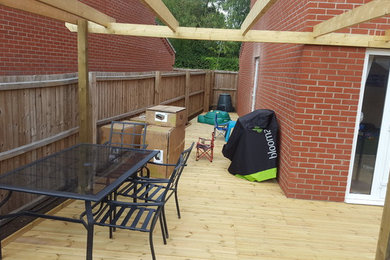 Photo of a large contemporary back partial sun garden for summer in Other with decking.