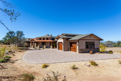 Example of a mid-sized arts and crafts beige one-story stone exterior home design in Phoenix