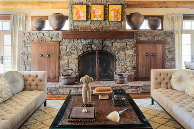 Living room - traditional medium tone wood floor living room idea in Denver with beige walls, a standard fireplace, a stone fireplace and no tv