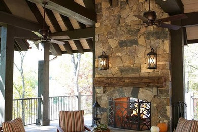 Patio - large rustic backyard patio idea in Other with a fire pit, decking and a roof extension