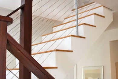 Example of a mid-sized transitional wooden u-shaped staircase design in Boston with painted risers