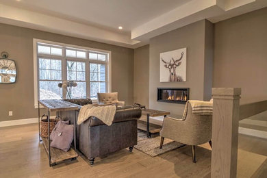 Mid-sized transitional formal and open concept light wood floor and brown floor living room photo in Other with brown walls, a ribbon fireplace, a metal fireplace and no tv